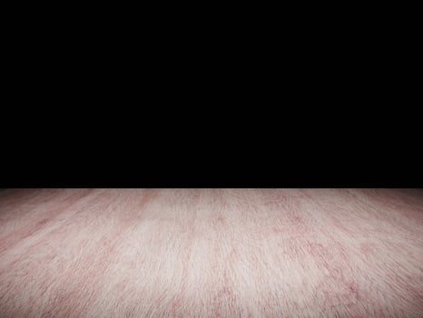 Dark wooden table surface with intricate grain pattern set against a black background. photo