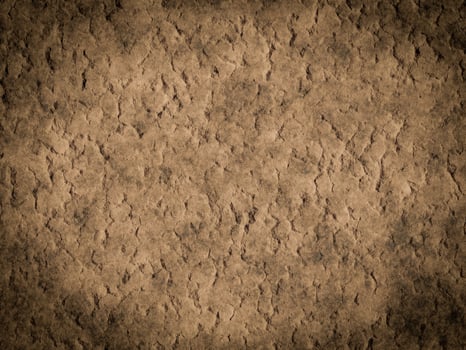 Rough cement texture with noticeable cracks and uneven surface patterns. photo