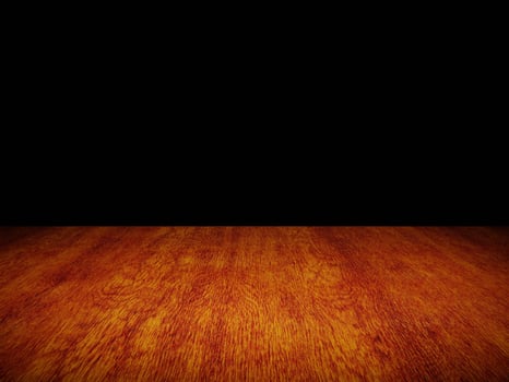 Smooth light wood table with gentle texture, perfectly framed against a black background. photo
