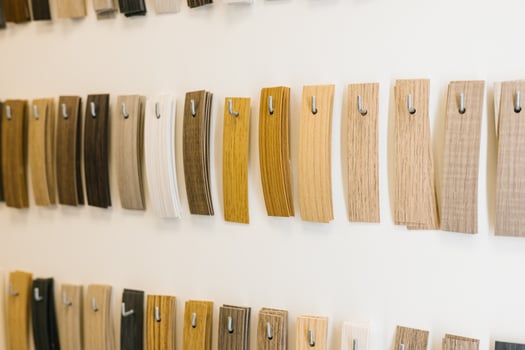 Variety of wood veneer samples on display in various shades and textures photo