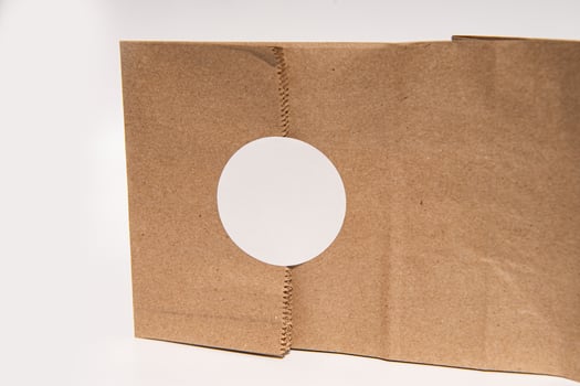 Cardboard box with circular cutout on white background photo