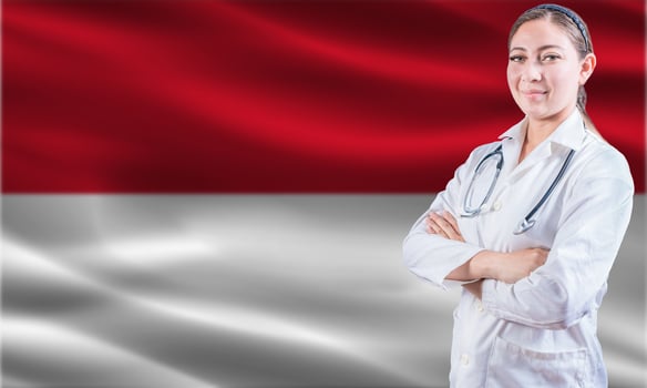 Female doctor on Monaco flag. Doctor with crossed arms on Monaco flag. Monaco health and care concept photo