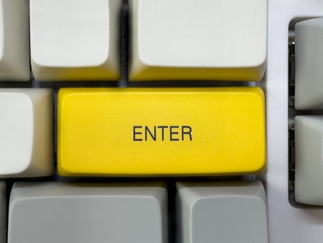 Big yellow Enter button with text on mechanical white keyboard, business concept, for advertising photo