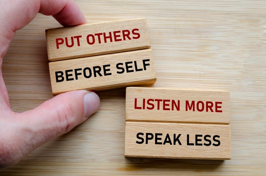 Put others before self message on wood cubes, highlighting a servant leadership mindset where empathy and humility come first photo