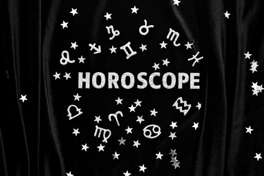 Abstract background with the inscription Horoscope on a black velvet background. photo