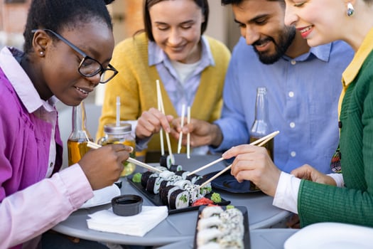 Group of friends sharing sushi together photo