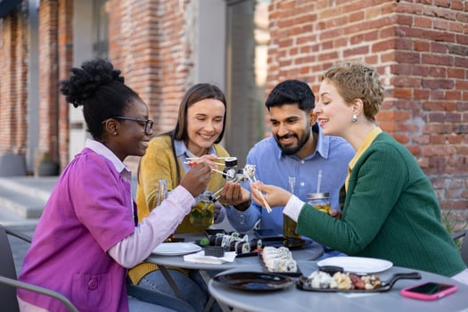 Friends sharing sushi at a restaurant photo