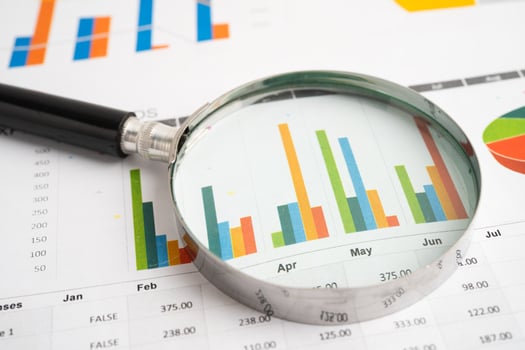 Magnifying glass on spreadsheet and graph photo