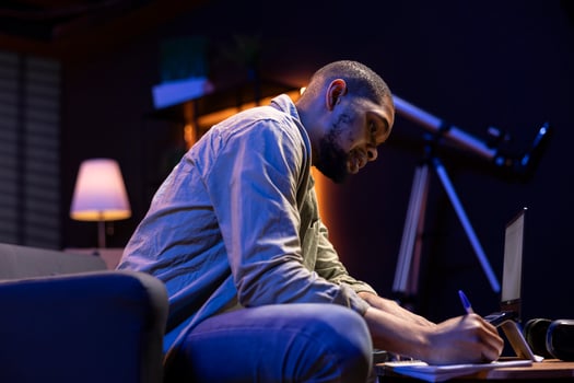 Man writing in a cozy workspace photo