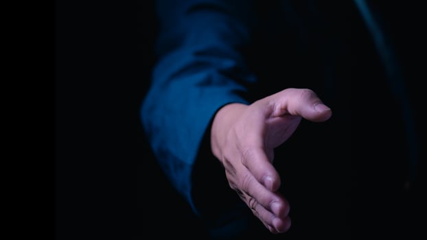 Businessman holding hands to shake hands to communicate business agreement and cooperation, concept of handshake or handshake of people meeting to cooperate or agree, greeting, accepting and thanking photo