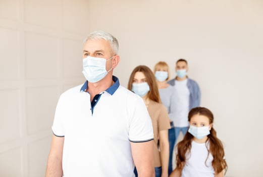 Senior man in protective mask waiting in queue for vaccine injection against coronavirus at clinic, blank space. Mature male patient standing in line for covid-19 immunization. Healthcare and medicine photo