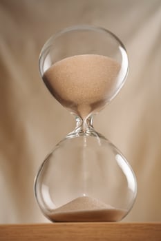 Hourglass with sand flowing between bulbs photo