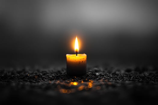 Candle flame in dark setting photo