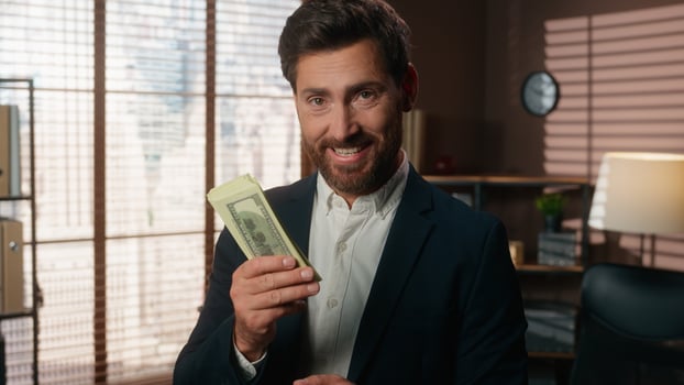 Caucasian middle-aged businessman male business man holding money sniffing smell aroma of cash happy rejoice job financial success smiling at camera in office finance achieve employer hold dollars photo
