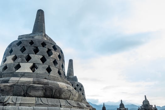 Dramatic Low Angle Borobudur Temple Structure Against Cloudy Sky Landscape photo