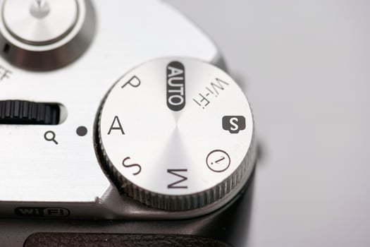 Camera settings dial showcasing various modes including auto, manual, and wireless settings for photography enthusiasts in a studio environment photo