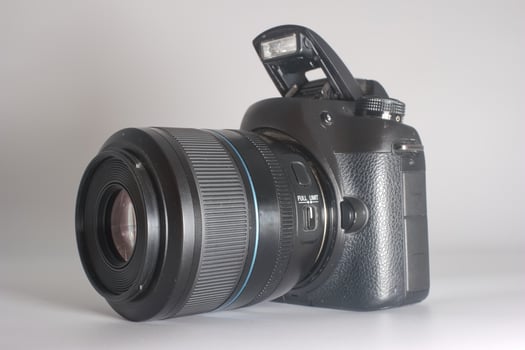 High quality DSLR camera on a light background showing detailed features and modern design photo