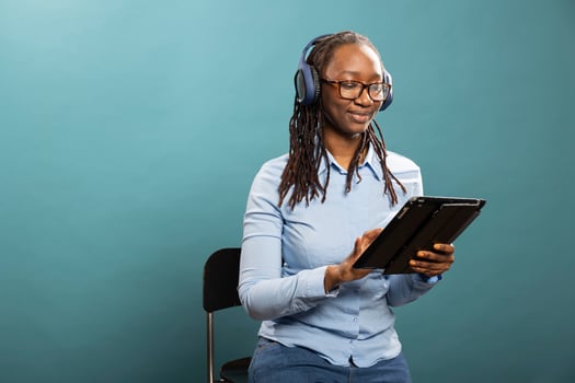 Woman with tablet and headphones photo