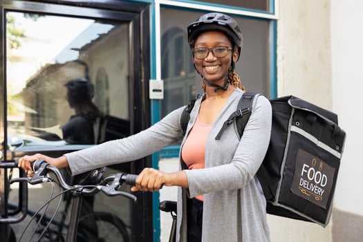 Person with bicycle and food delivery bag photo