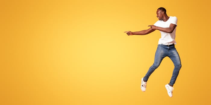 Man jumping in casual outfit photo