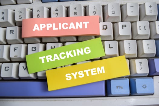 Concept of Applicant, tracking, and system write on sticky notes isolated on keyboard. photo