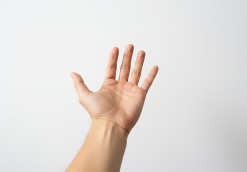 A hand reaching up to the sky photo