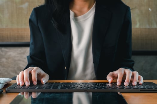 Close-up of a professional typing on a keyboard, highlighting modern office work and technology. photo