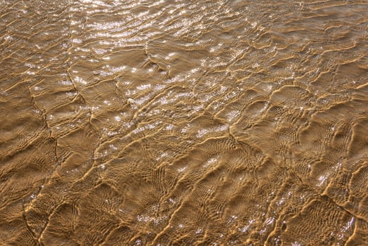 a waves crash on the beach sand for background photo