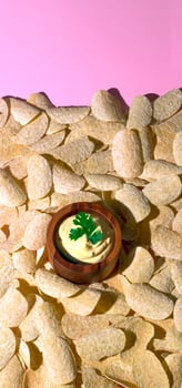 Potato Chips and Creamy Dip on Pink Background photo