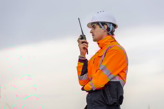 Maritime Safety Engineer Working at Port Terminal with Walkie Talkie, Dock Worker in Safety Uniforms Using Technology for Port Operations, Industrial Engineer Collaborating at Harbor Site photo