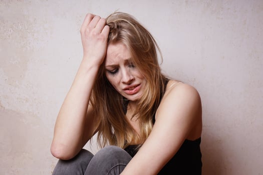 forlorn young woman with smudged makeup crying in despair feeling sad and lonely photo