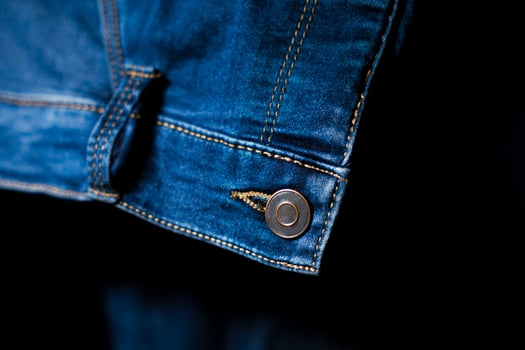 Close-Up of Button and stitching on Blue Jeans, Detailed Denim Design photo