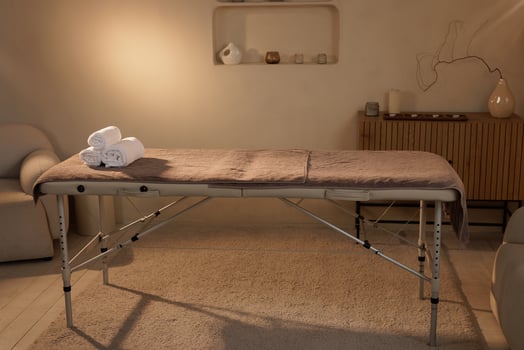 Massage Table with Rolled Towels in Cozy Spa Interior for Wellness and Relaxation Treatments photo
