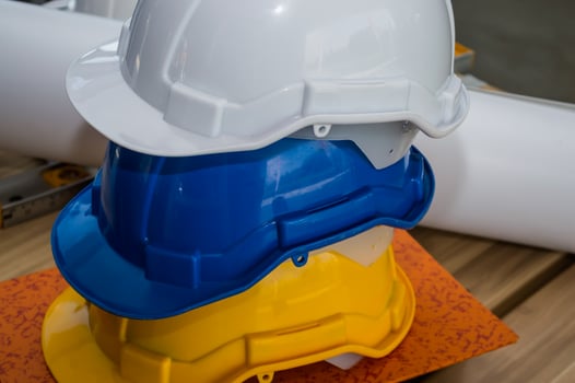 Three hard hats stacked on top of each other photo