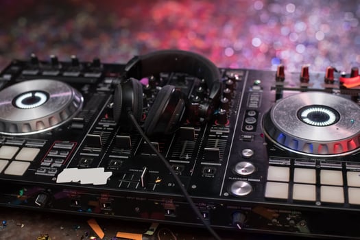 A dj mixer with headphones and a microphone photo