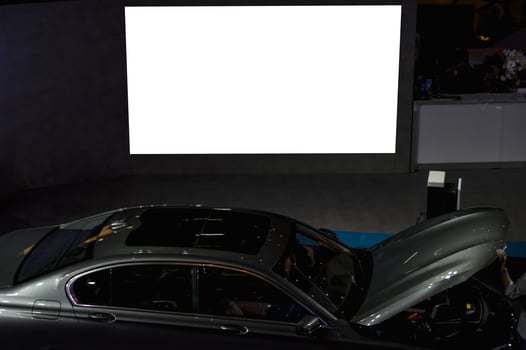 A man is looking at a car photo