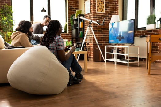 Friends playing video games in living room photo