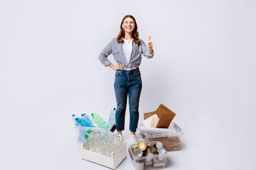 Sustainability Concept. Cheerful Millennial Woman Standing Next To Containers With Different Materials For Recycling And Showing Thumb Up At Camera,Happy Eco-Activist Lady Enjoying Sorting Garbage photo