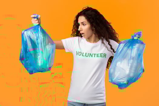 Woman holding trash bags with surprise expression photo