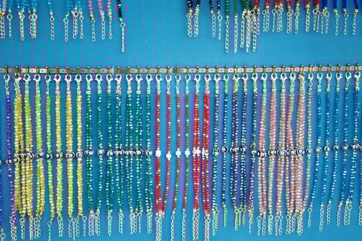 Colorful handmade necklaces displayed at a market booth photo