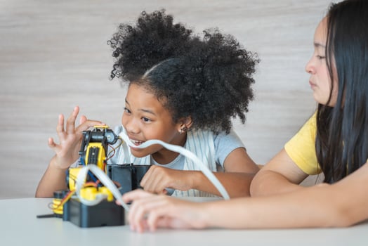 Young Girls Engaged in Robotics and STEM Learning, Diverse Kids Building a Robot Arm in a Science Workshop, Two Girls Exploring Technology and Innovation photo