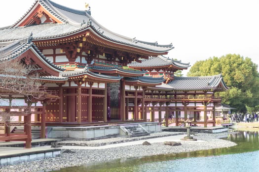 Byodo-in Temple Uji Kyoto Japan, Traditional Asian architecture by a serene waterway. photo
