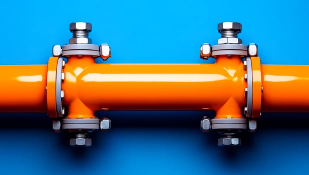 Bright orange pipe with metal fittings. A vibrant orange pipe is secured with silver metal fasteners against a blue background, showcasing industrial design. photo