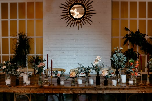 Elegant rustic dining setup with floral centerpieces and modern decor photo