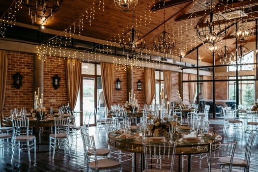 Elegant rustic wedding venue with string lights and floral decor photo