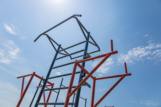 Parallel bars stand tall in an outdoor gym, promoting active lifestyles and strength training under a bright sun photo