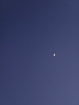 Capture the night sky a crescent moon shining in the dark blue sky photography and astronomy image photo