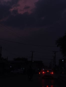 Night rainy road driving car lights dark sky clouds cityscape urban scene travel photography moody photo