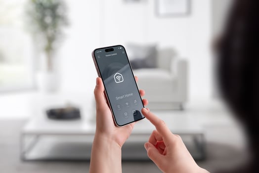 Woman interacting with smart home interface on mobile phone in modern interior environment photo