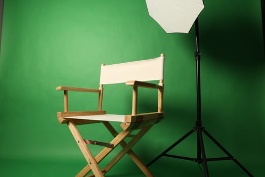 Chair of Film Director Directors chair in green screen studio setup with softbox lighting. photo